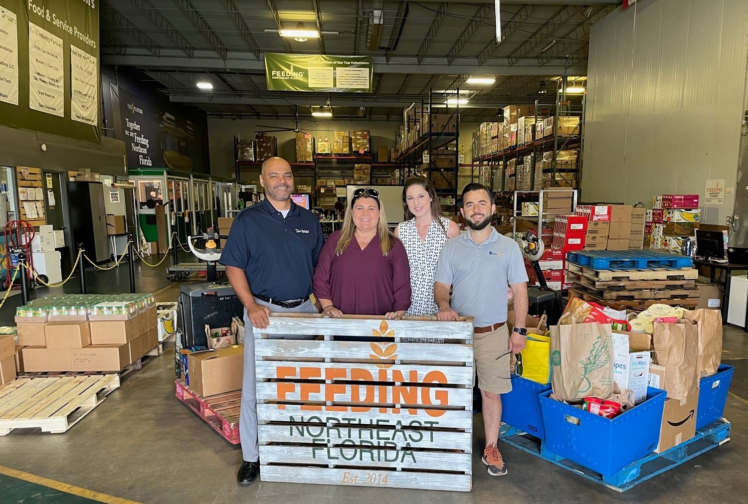 Pictured from left are Eric Pledger, Nicole Pare, Mandy Wicker and Taulant Marra prepare to donate 960 pounds of food to those in need.